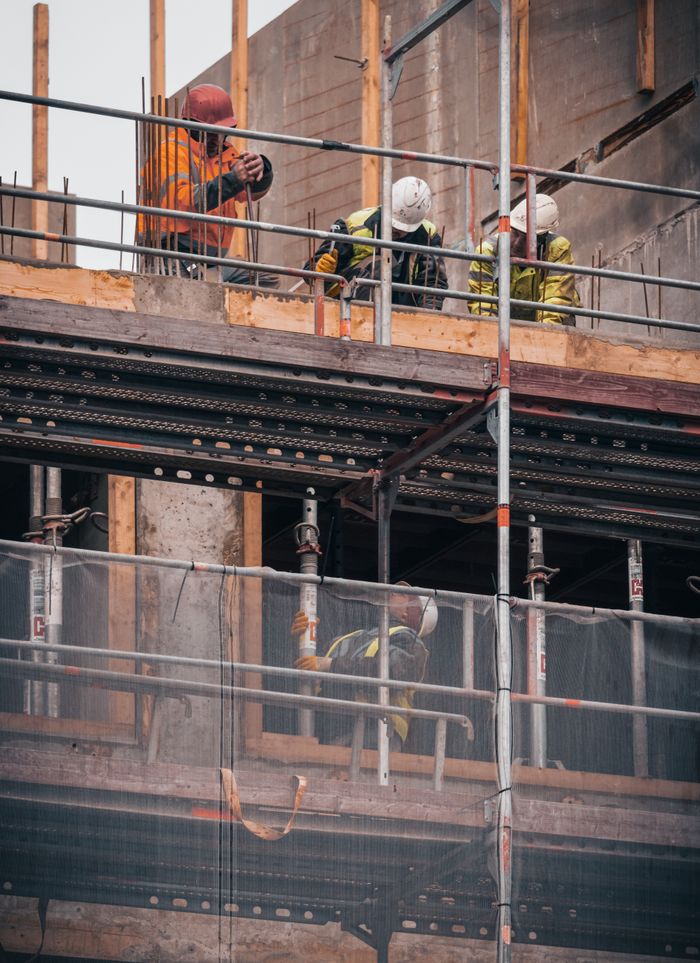services-02 Construction workers engage in building tasks on a scaffold in Hamburg.